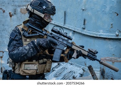 Modern Soldier In Black Multicam Uniform With Rifle, Urban Background 