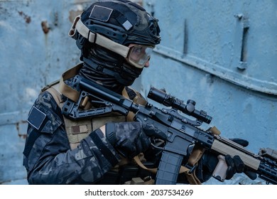 Modern Soldier In Black Multicam Uniform With Rifle, Urban Background 