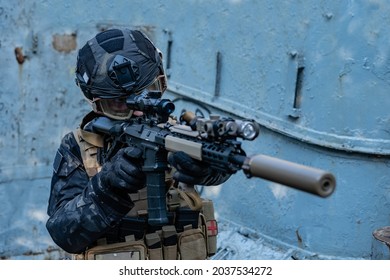 Modern Soldier In Black Multicam Uniform With Rifle, Urban Background 