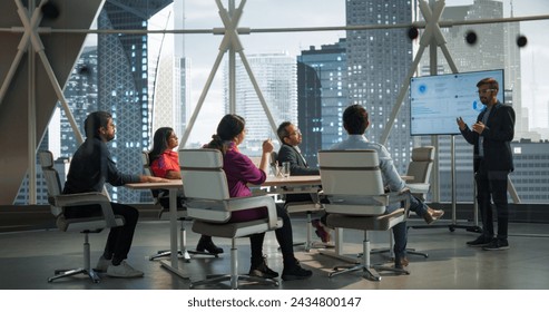 Modern South Asian Business Office Meeting: Confident Indian Manager Uses Interactive Display, Makes Report to a Group of Corporate Partners, Shows Statistics, Growth and Financial Analytics - Powered by Shutterstock