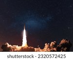 Modern space rocket with blast and smoke successfully takes off into starry space in the dark. New spaceship lift off, is flying on a space mission 