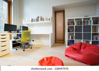 Modern spacious study room with red bag chair - Shutterstock ID 238947970