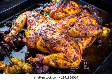 Modern spatchcocked barbecue chicken al mattone chili with red and green grapes as top view on an old metal sheet  - Powered by Shutterstock