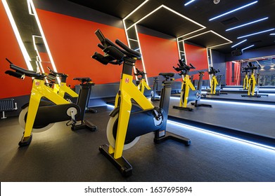 Modern Spinning Class, Gym With Indoor Bikes In A Row