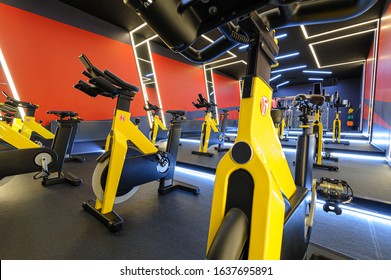 Modern Spinning Class, Gym With Yellow Indoor Bikes