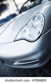 Modern Sport Car Hood. Focus On Headlight.