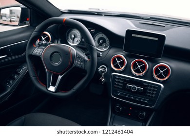 Modern and sport car interior with comfortable dark leather seats, multimedia and dashboard