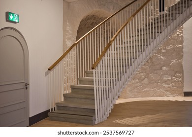 A modern staircase with minimalist railing, contrasting stone and wood textures, creating a blend of contemporary and rustic interior design. - Powered by Shutterstock