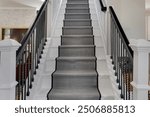 Modern Staircase With A Runner Carpet And Sleek Black Railing