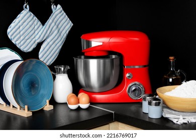 Modern Stand Mixer, Dishware And Ingredients On Countertop In Kitchen