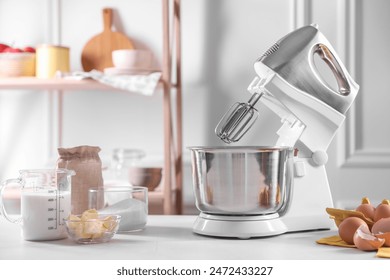 Modern stand mixer and ingredients for dough on white table indoors - Powered by Shutterstock