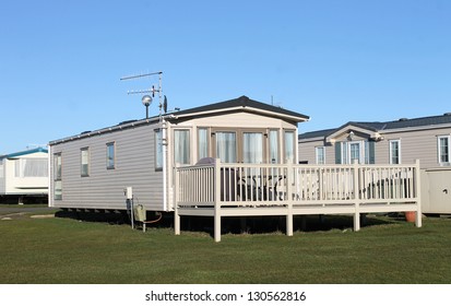 Modern static caravans in park with blue sky background.