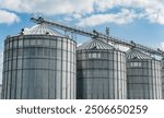 Modern steel agricultural grain granary silos. Agricultural silos for storage of grain harvest at an agricultural production farm.