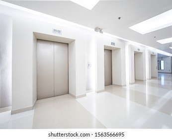 Modern Steel Elevator Cabins In A Business Lobby Or Hotel, Store, Interior, Office,perspective Wide Angle. Three Elevators In Hotel Lobby.