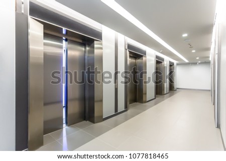 Modern steel elevator door almost open cabins in a business lobby or Hotel, Store, interior, office,perspective wide angle. Four elevators in hotel lobby.