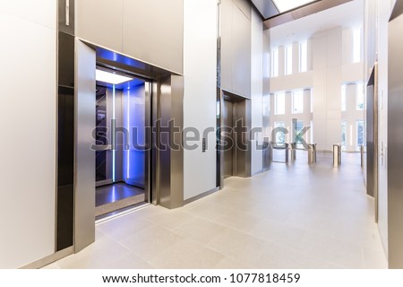Modern steel elevator doors opened cabins in a business lobby or Hotel, Store, interior, office,perspective wide angle. elevators in hotel lobby.