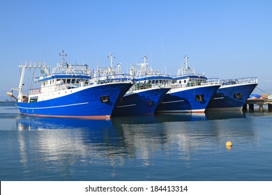 Modern steel fishing ships docked in port 
