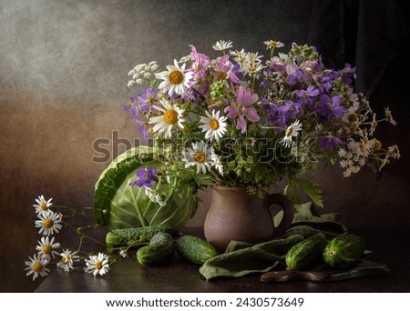 Modern still life with a bouquet of wildflowers and vegetables on a wooden table.