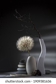 Modern still life with dandelion and stones.