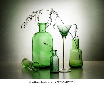 Modern still life with glass bottles and dry branches. - Shutterstock ID 2254682243