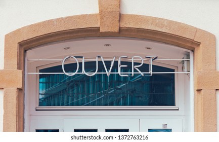 Modern Stone Archway Door With An Off Neon French Open Sign 