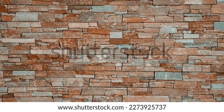 Modern stone brick wall surface background. Brown masonry wall of stones with irregular pattern texture background
