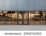 Modern storefront with large glass windows and central entrance, ideal for retail or commercial use, featuring ample space for signage. Front view