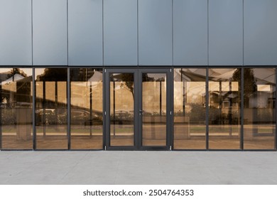 Modern storefront with large glass windows and central entrance, ideal for retail or commercial use, featuring ample space for signage. Front view