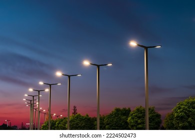 Modern street LED lighting pole. Urban electro-energy technologies. A row of street lights against the night sky - Shutterstock ID 2224502473
