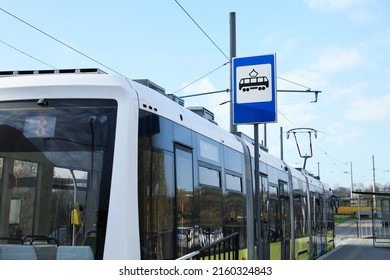 Modern Streetcar Near Tram Stop Sign Outdoors