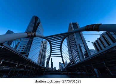 Modern structure bridge shape and building at train station in Bangkok, Thailand. Blue tone