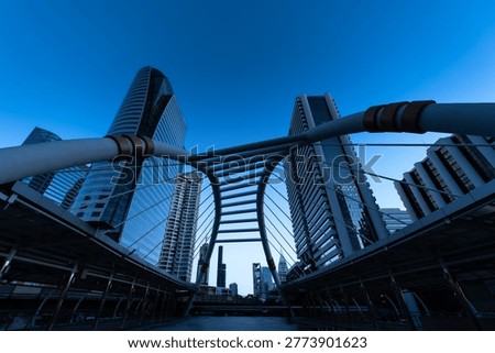 Modern structure bridge shape and building at train station in Bangkok, Thailand. Blue tone