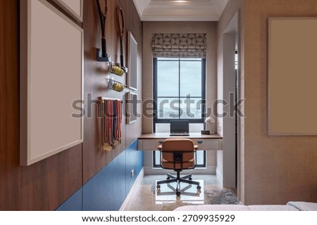 Modern study nook area featuring tennis themed decor, medals, window, and a laptop on the desk.