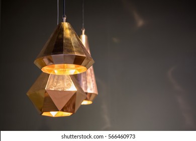 Modern style bronze decoration lamps and lampshades against dark  wall.