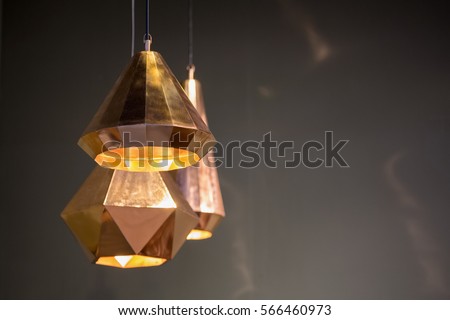 Modern style bronze decoration lamps and lampshades against dark  wall.