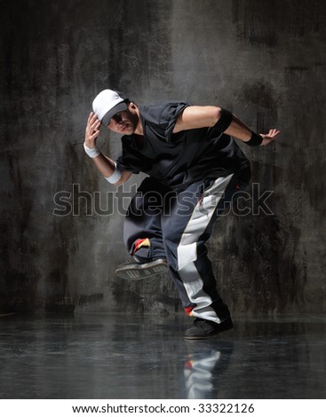 modern style dancer posing on dirty grunge background