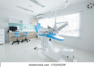 Modern style interior shot of dental clinic with blue dental chair.