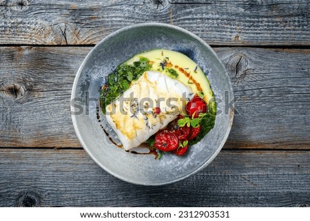 Modern style traditional fried skrei cod fish filet with mashed potato cream and coriander lime relish served as top view on Nordic design plate with copy space  Foto d'archivio © 