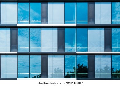 Modern Suburban Low Rise Office Building With The Sky Reflecting In Great Summer Sun