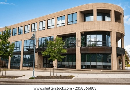 Modern suburban low rise office building. Architectural Exterior of Modern Low Rise Commerical Office Building Facade. Exterior of an office building with parking lot on a sunny summer day