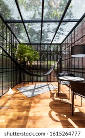 Modern Sunroom With A Hammock And Some Plants