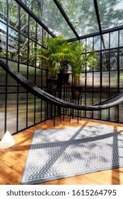 Modern Sunroom With A Hammock And Some Plants