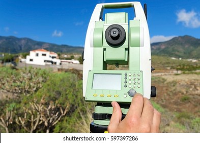 Modern surveyor equipment, theodolite or tacheometer  used in surveying and building construction for precise measurement. Total station outdoor at construction site.