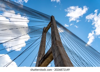 Modern Suspension Bridge Across Reservoir Los Barrios De Luna In Castile And Leon, Spain. Carlos Fernandez Casado Bridge. Low Angle View Against Sky