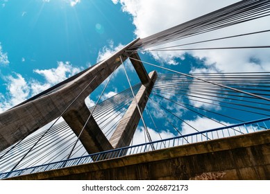 Modern Suspension Bridge Across Reservoir Los Barrios De Luna In Castile And Leon, Spain. Carlos Fernandez Casado Bridge. Low Angle View Against Sky