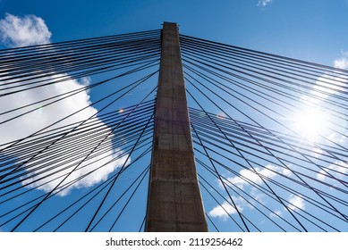 Modern Suspension Bridge Across Reservoir Los Barrios De Luna In Castile And Leon, Spain. Carlos Fernandez Casado Bridge. Low Angle View Against Sky