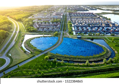 Modern sustainable neighbourhood in Almere, The Netherlands. The city heating (stadswarmte) in the district is partially powered by a solar panel island (Zoneiland). Aerial view.