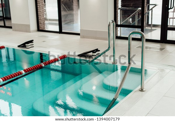 modern swimming pool with lane dividers, pull\
buoys and swimming\
kickboards