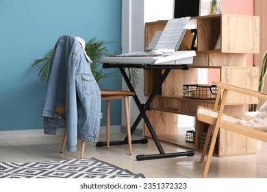 Modern synthesizer and chairs in room
