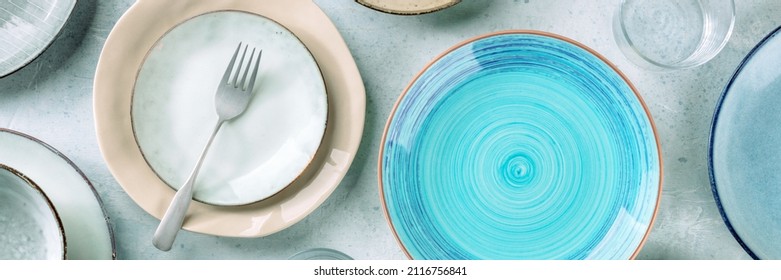 Modern Tableware Panorama With A Blue Plate, A Fork, And Many Other Clean Dishes. Elegant Catering Panoramic Banner, Shot From Above